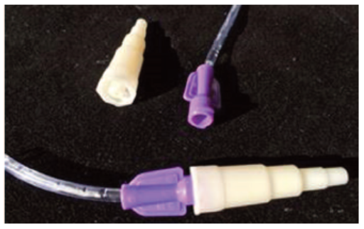 Figure 1. Transition adapter now accompanies enteral feeding administration sets. It can be removed for use with feeding tubes that have an ENFit connection, or left in place to use with legacy feeding tubes that have a Luer connector.